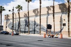 A ground level mural shows a monochrome horned toad in all shades of chic black and white, the only splash of color coming from a spraying stream of red blood coming from the animal’s otherwise serene eye. It is in an incredible realistic style and massive size.