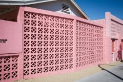 Photo of a decorative wall outside at Las Vegas Motel made of pink decorative brick.