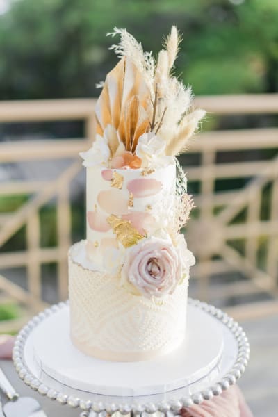 Close up of wedding cake with dried flowers.