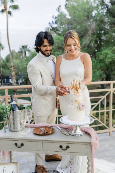 Wedding couple cutting wedding cake.