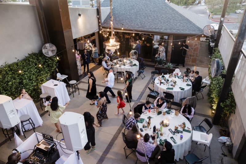 A high angle photo. Wedding guests dance, dine and mingle in the courtyard of Forge Social House.