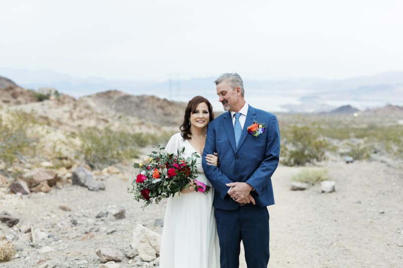 A middle-aged bride and groom pose for wedding pictures in the desert near Boulder City, Nevada.