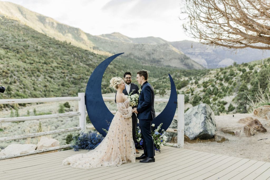 Wedding ceremony in front of moon art.